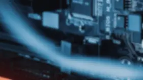 Blurred close-up of a computer motherboard showcasing various components such as capacitors and circuits, representing deep product expertise in handling and refurbishing a wide range of technology products including laptops, desktops, mobile devices, and data center equipment.